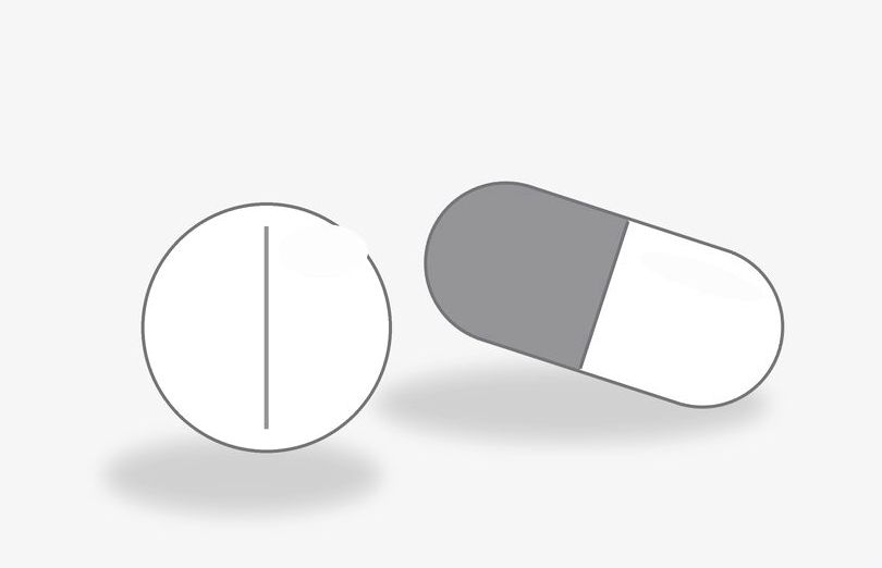 Two oral hair-loss pills — a capsule and a tablet